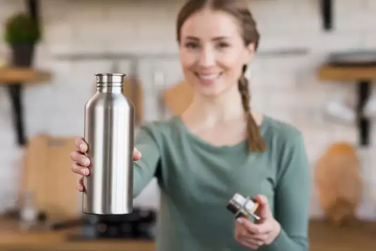 portrait smiling young woman holding thermos